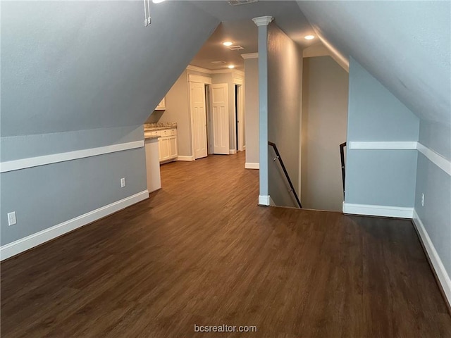 additional living space with wood-type flooring and lofted ceiling