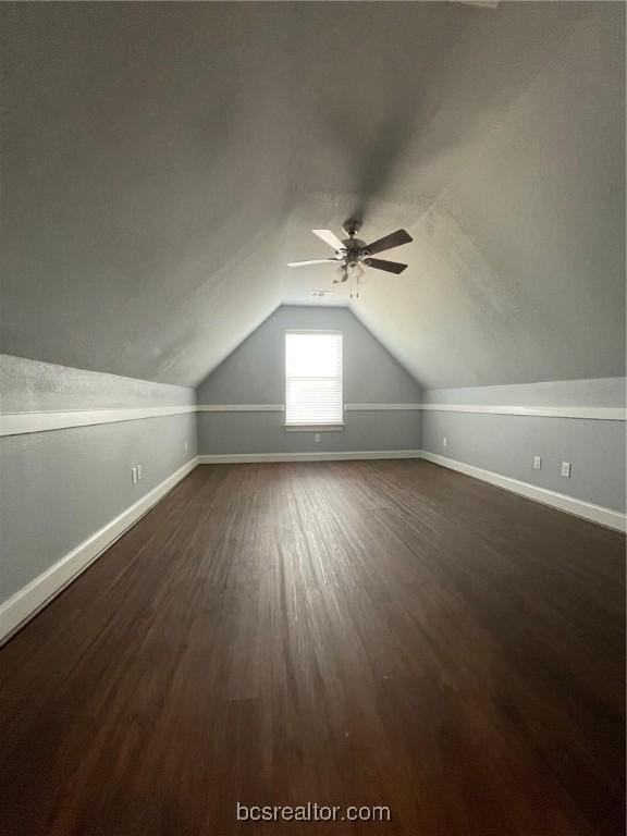 additional living space featuring ceiling fan, dark hardwood / wood-style flooring, and lofted ceiling