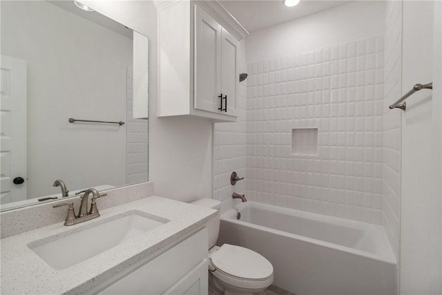 full bathroom with vanity, toilet, and tiled shower / bath combo