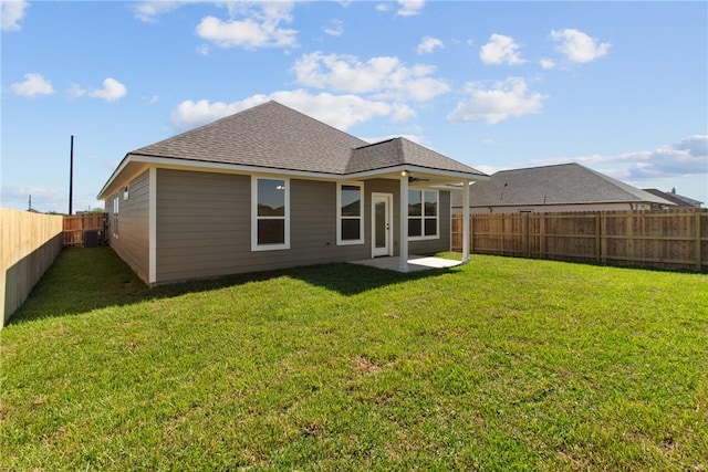 back of house featuring a lawn