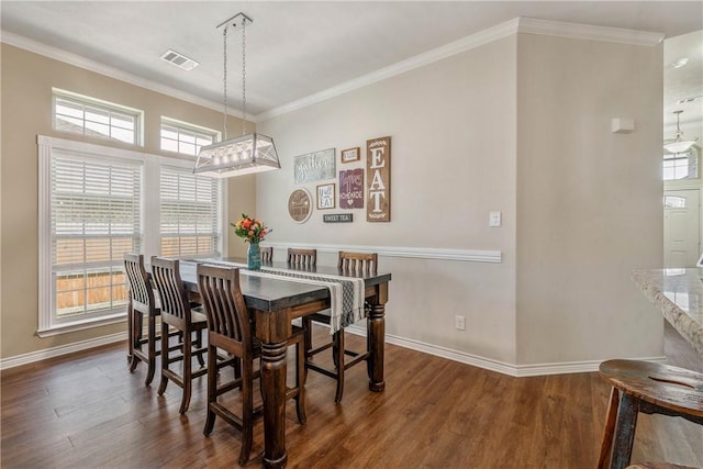 dining space featuring dark hardwood / wood-style flooring and ornamental molding