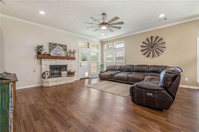 living room with dark hardwood / wood-style floors, a fireplace, crown molding, and ceiling fan