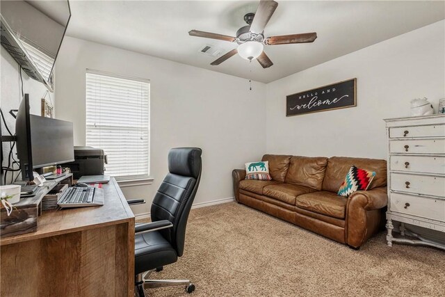 carpeted office space featuring ceiling fan