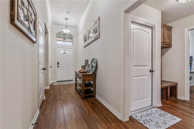 entryway with ornamental molding and dark wood-type flooring