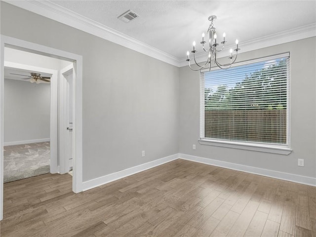 empty room featuring ceiling fan with notable chandelier, hardwood / wood-style flooring, and ornamental molding