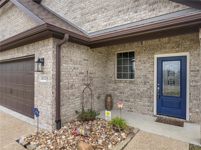 view of exterior entry featuring a garage