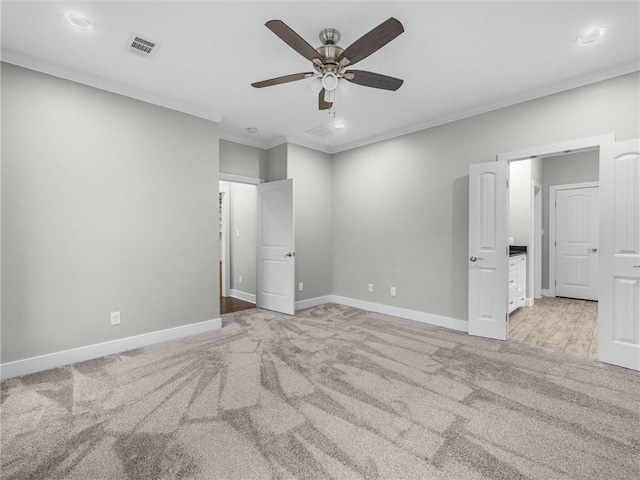 unfurnished bedroom with ceiling fan, light colored carpet, and ornamental molding