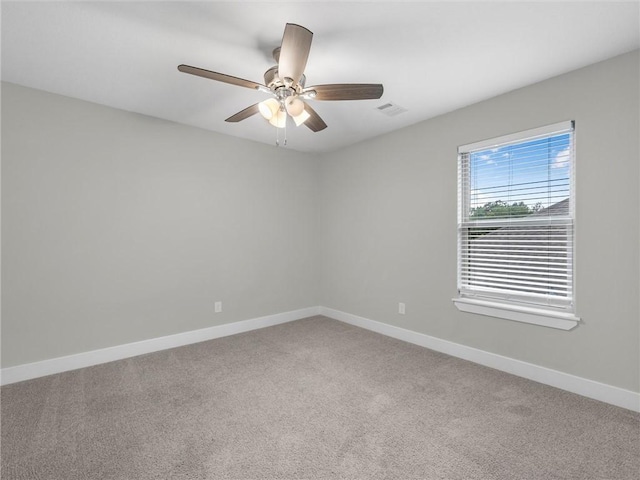 carpeted spare room with ceiling fan