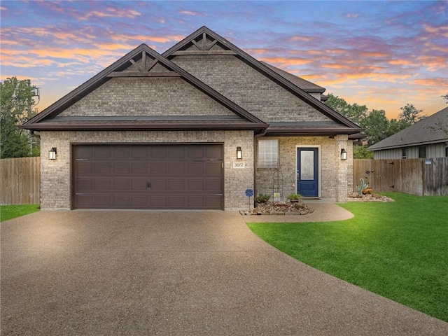 view of front facade featuring a garage and a lawn