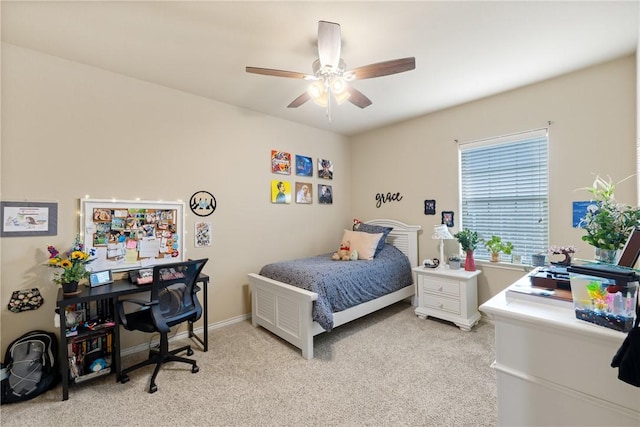 bedroom featuring light carpet, a ceiling fan, and baseboards