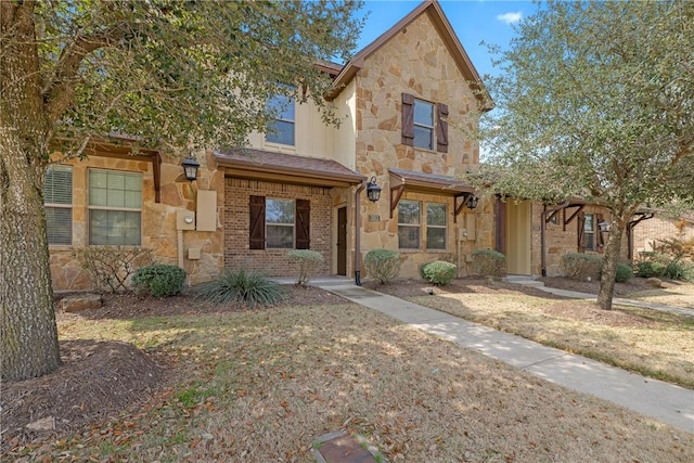 view of front of house featuring stone siding and brick siding