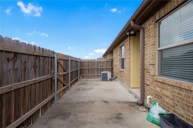 view of patio / terrace with fence and central air condition unit