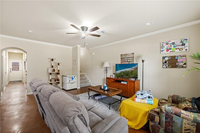 living room featuring arched walkways, ceiling fan, visible vents, stairway, and crown molding