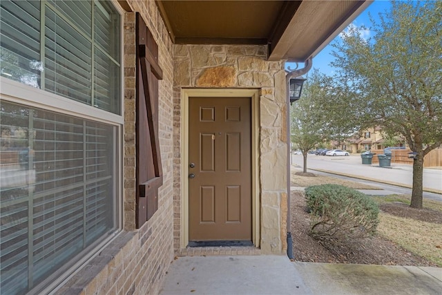 entrance to property featuring stone siding