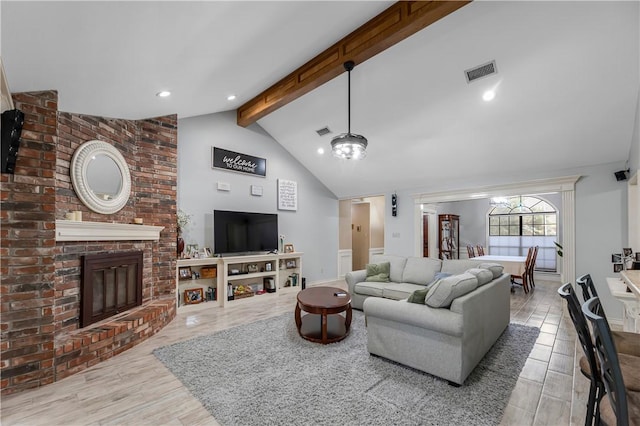 3003 Aztec St, College Station, TX 77845 - living room with a brick fireplace, recessed lighting, and wood finished floors