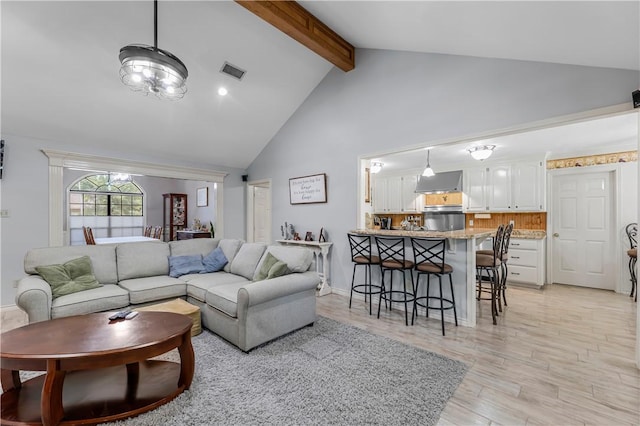 3003 Aztec St, College Station, TX 77845 - living area featuring high vaulted ceiling, beam ceiling, light wood finished floors, and baseboards