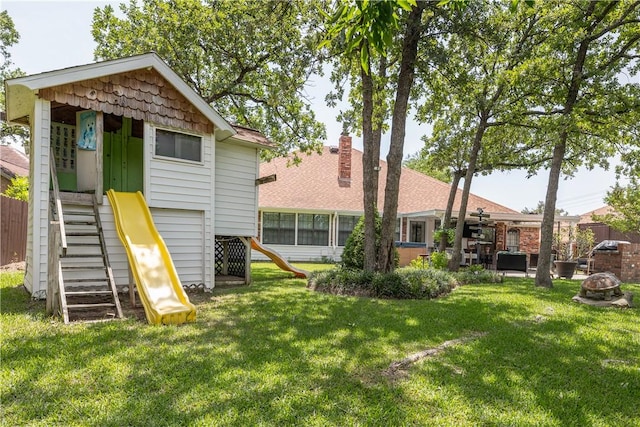 3003 Aztec St, College Station, TX 77845 - back of house with a playground and an outdoor fire pit