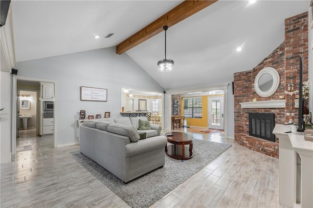 3003 Aztec St, College Station, TX 77845 - living room featuring beam ceiling, a brick fireplace, high vaulted ceiling, light wood finished floors, and baseboards