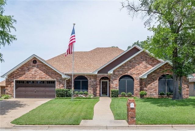 3003 Aztec St, College Station, TX 77845 - view of front of house with a front yard, concrete driveway, a garage, and a shingled roof