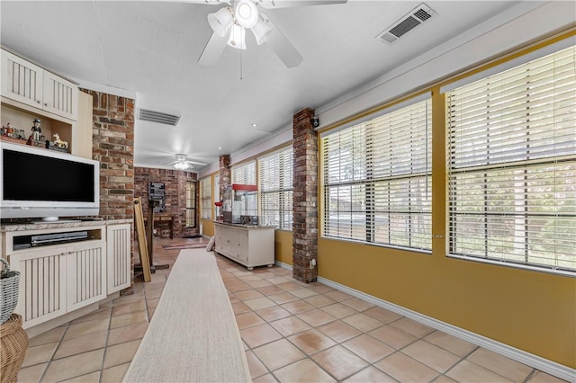 3003 Aztec St, College Station, TX 77845 - kitchen featuring ceiling fan, light tile patterned flooring, baseboards, and white cabinets