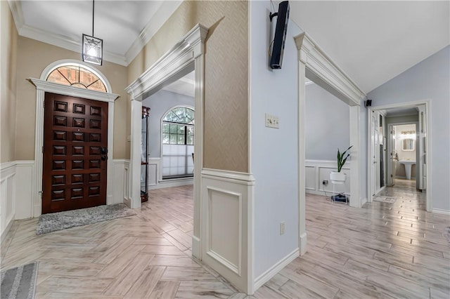3003 Aztec St, College Station, TX 77845 - entrance foyer with a decorative wall, wainscoting, ornamental molding, lofted ceiling, and parquet floors