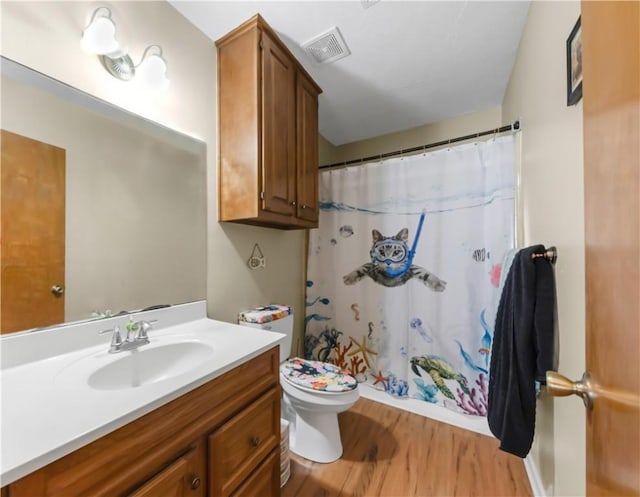 2306 Windsor Dr, Bryan, TX 77802 - full bath with vanity, wood finished floors, and curtained shower