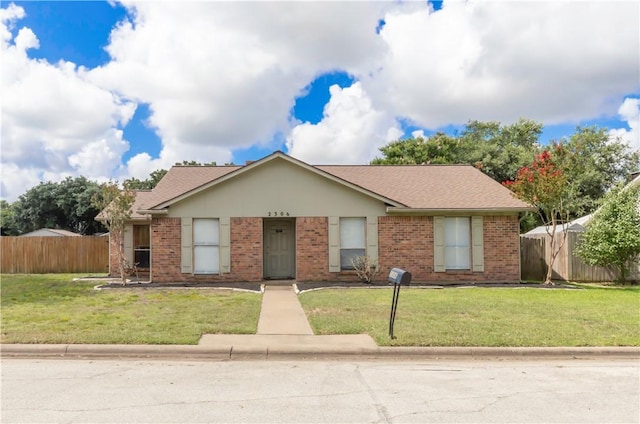 2306 Windsor Dr, Bryan, TX 77802 - view of front facade with brick siding and roof with shingles