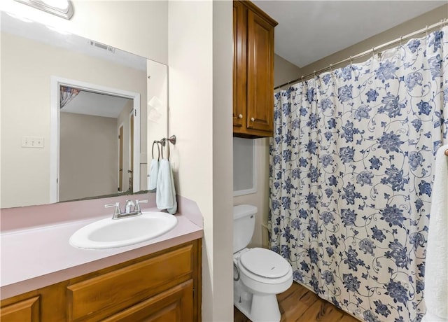2306 Windsor Dr, Bryan, TX 77802 - full bathroom featuring vanity, a shower with shower curtain, and wood finished floors