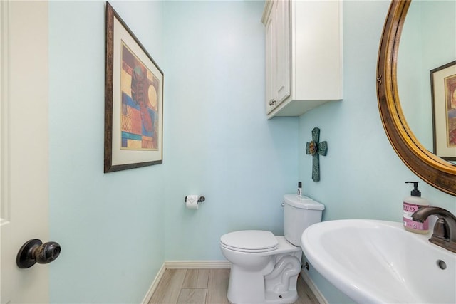 5249 Drake Dr, College Station, TX 77845 - bathroom featuring a sink, toilet, and baseboards