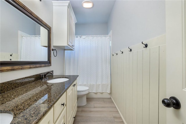 5249 Drake Dr, College Station, TX 77845 - bathroom featuring wood finished floors, vanity, toilet, and shower / tub combo with curtain