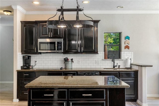 5249 Drake Dr, College Station, TX 77845 - kitchen with black appliances, a sink, ornamental molding, dark cabinets, and dark stone countertops