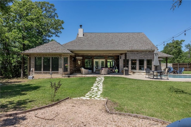 5249 Drake Dr, College Station, TX 77845 - back of property with brick siding, a patio area, a chimney, and outdoor lounge area