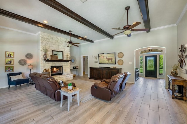 5249 Drake Dr, College Station, TX 77845 - living room featuring a ceiling fan, beamed ceiling, light wood finished floors, a fireplace, and baseboards
