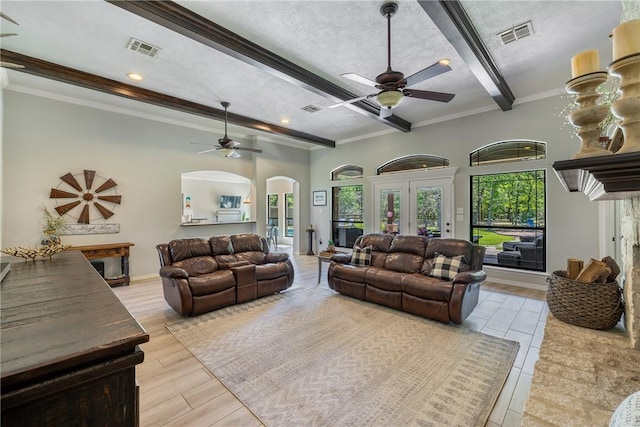 5249 Drake Dr, College Station, TX 77845 - living room with ceiling fan, beamed ceiling, arched walkways, crown molding, and recessed lighting