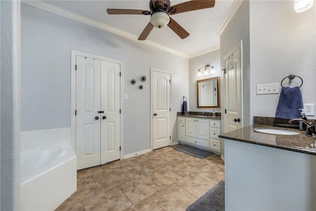 5249 Drake Dr, College Station, TX 77845 - bathroom with crown molding, two vanities, ceiling fan, and a garden tub