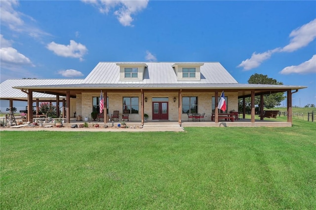 back of property with a yard and french doors