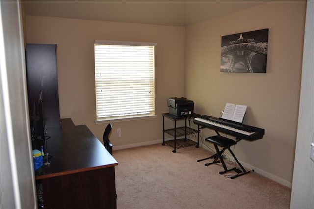 carpeted home office featuring baseboards and plenty of natural light