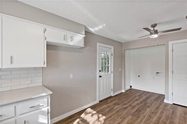 kitchen featuring dark hardwood / wood-style flooring, tasteful backsplash, a textured ceiling, ceiling fan, and white cabinets