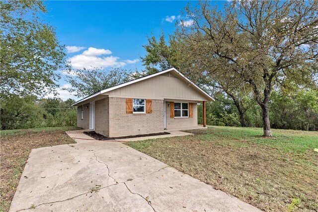 view of side of home featuring a lawn