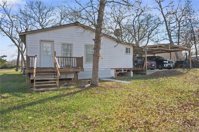 back of house with a yard and a carport