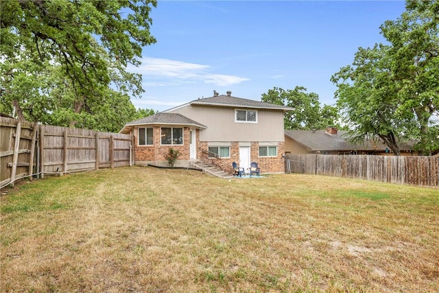 1436 Magnolia Dr, College Station, TX 77840 - back of house with a yard, brick siding, and a fenced backyard