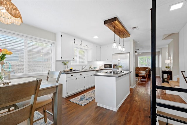 1436 Magnolia Dr, College Station, TX 77840 - kitchen featuring white cabinetry, visible vents, dark wood-style flooring, and appliances with stainless steel finishes