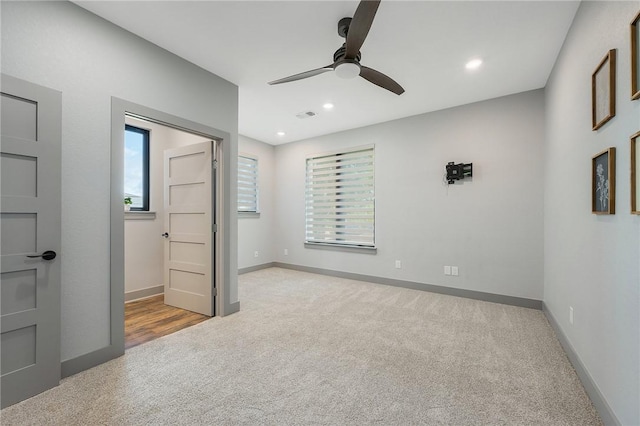 unfurnished bedroom with recessed lighting, light colored carpet, visible vents, and baseboards