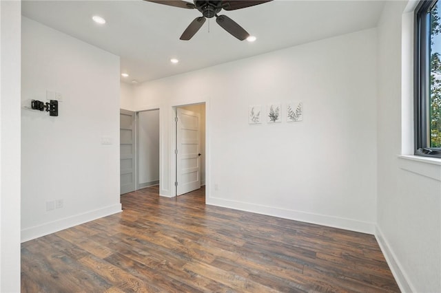 empty room featuring a ceiling fan, recessed lighting, dark wood-style flooring, and baseboards