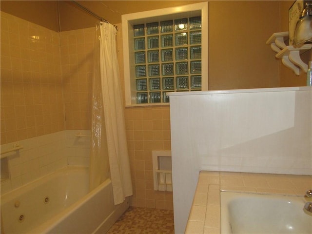 full bathroom with shower / bath combo with shower curtain and tile walls
