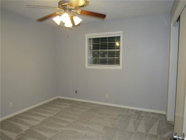 unfurnished room featuring ceiling fan, carpet floors, and baseboards
