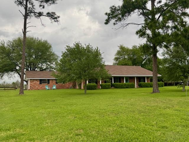 back of property with a lawn