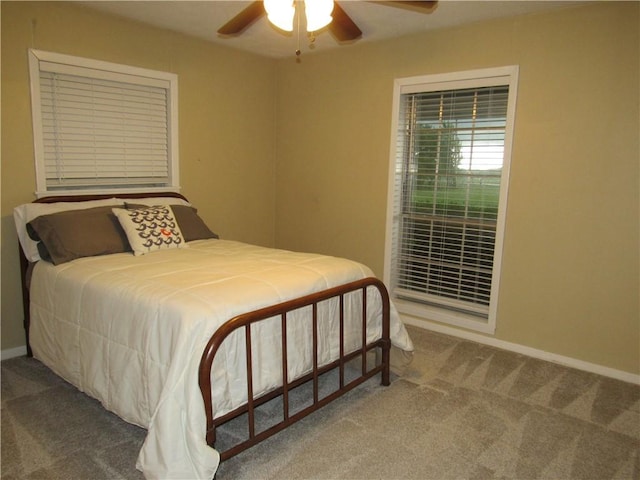 carpeted bedroom with baseboards and ceiling fan