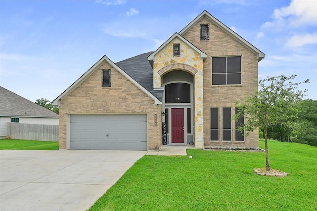 view of front of house with a garage and a front lawn