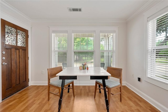 1725 Harvey Mitchell Pkwy, College Station, TX 77840 - dining space with plenty of natural light, light wood finished floors, crown molding, and baseboards